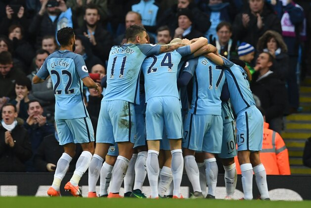Manchester City players celebrate the opening goal scored by Manchester City's Argentinian striker Sergio Aguero during the English Premier League football match between Manchester City and Middlesbrough at the Etihad Stadium in Manchester, north west England, on November 5, 2016. / AFP / PAUL ELLIS / RESTRICTED TO EDITORIAL USE. No use with unauthorized audio, video, data, fixture lists, club/league logos or 'live' services. Online in-match use limited to 75 images, no video emulation. No use in betting, games or single club/league/player publications.  /         (Photo credit should read PAUL ELLIS/AFP/Getty Images)
