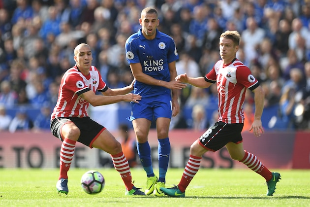 LEICESTER, ENGLAND - OCTOBER 02: Islam Slimani of Leicester City passes the ball while Oriol Romeu of Southampton (L) and Steven Davis of Southampton (R) watches during the Premier League match between Leicester City and Southampton at The King Power Stadium on October 2, 2016 in Leicester, England.  (Photo by Laurence Griffiths/Getty Images)