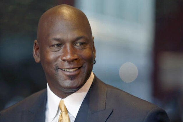 FILE - In this Aug. 21, 2015, file photo, former NBA star and current owner of the Charlotte Hornets, Michael Jordan, smiles at reporters in Chicago. Jordan announced Monday, July 25, 2016,  he’s giving $1 million to the Institute for Community-Police Relations and $1 million to the NAACP Legal Defense Fund to help build trust between blacks and law enforcement following several disturbing clashes around the country. (AP Photo/Charles Rex Arbogast, File)