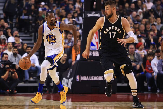 TORONTO, ON - NOVEMBER 16:  Kevin Durant #35 of the Golden State Warriors dribbles the ball as Jonas Valanciunas #17 of the Toronto Raptors defends during the first half of an NBA game at Air Canada Centre on November 16, 2016 in Toronto, Canada.  NOTE TO USER: User expressly acknowledges and agrees that, by downloading and or using this photograph, User is consenting to the terms and conditions of the Getty Images License Agreement.  (Photo by Vaughn Ridley/Getty Images)