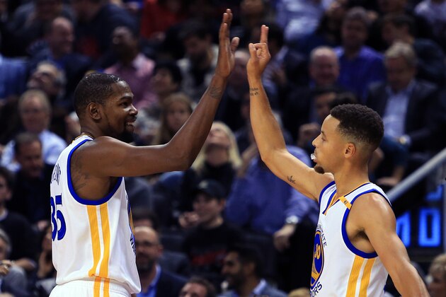 TORONTO, ON - NOVEMBER 16:  Kevin Durant #35 and Steph Curry #30 of the Golden State Warriors high five during the first half of an NBA game against the Toronto Raptors at Air Canada Centre on November 16, 2016 in Toronto, Canada.  NOTE TO USER: User expressly acknowledges and agrees that, by downloading and or using this photograph, User is consenting to the terms and conditions of the Getty Images License Agreement.  (Photo by Vaughn Ridley/Getty Images)