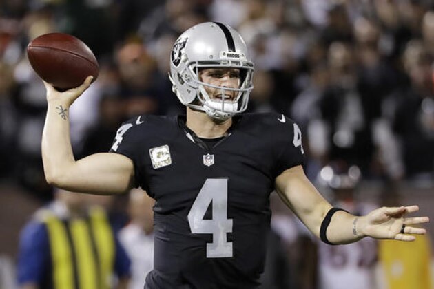 Oakland Raiders quarterback Derek Carr (4) passes against the Denver Broncos during the first half of an NFL football game in Oakland, Calif., Sunday, Nov. 6, 2016. (AP Photo/Marcio Jose Sanchez)