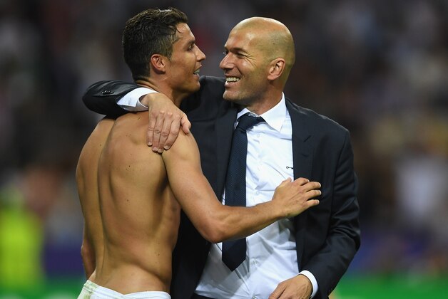 MILAN, ITALY - MAY 28:  Cristiano Ronaldo of Real Madrid celebrates with head coach Zinedine Zidane after victory in the UEFA Champions League Final match between Real Madrid and Club Atletico de Madrid at Stadio Giuseppe Meazza on May 28, 2016 in Milan, Italy.  (Photo by Laurence Griffiths/Getty Images)