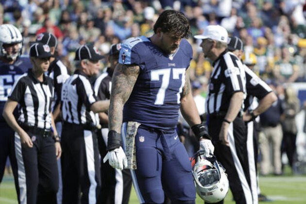 Tennessee Titans tackle Taylor Lewan (77) leaves the field after being ejected in the first half of an NFL football game against the Green Bay Packers Sunday, Nov. 13, 2016, in Nashville, Tenn. (AP Photo/James Kenney)