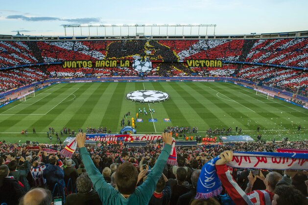 Fans hold scarves before the UEFA Champions League quarter-finals second leg football match between Club Atletico de Madrid vs FC Barcelona at the Vicente Calderon stadium in Madrid on April 13, 2016. / AFP / CURTO DE LA TORRE        (Photo credit should read CURTO DE LA TORRE/AFP/Getty Images)