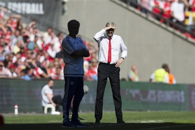 Arsenal's manager Arsene Wenger, right, stands alongside Chelsea's manager Jose Mourinho during the English Community Shield soccer match between Arsenal and Chelsea at Wembley Stadium, London, England, Sunday Aug. 2, 2015. (AP Photo/Jon Super)