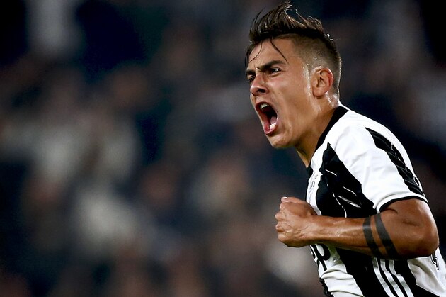 Juventus' forward Paulo Dybala from Argentina celebrates after scoring during the Italian Serie A football match Juventus vs Udinese on October 15, 2016 at the 'Juventus Stadium' in Turin.   / AFP / MARCO BERTORELLO        (Photo credit should read MARCO BERTORELLO/AFP/Getty Images)