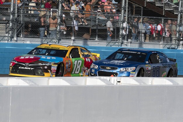 Nov 13, 2016; Avondale, AZ, USA; Sprint Cup Series driver Kyle Busch (18) and driver Alex Bowman (88) during the Can-Am 500 at Phoenix International Raceway. Mandatory Credit: Jerome Miron-USA TODAY Sports