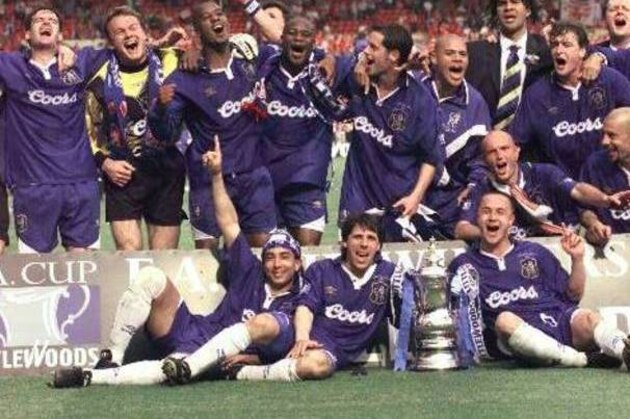 Chelsea and Italy's Gianfranco Zola, (centre foreground), his countryman Robert Di Matteo, (left), and team captain Dennis Wise, celebrate with the rest of their team, including Dutch coach Ruud Gullit (in suit), after winning the English Football Association Cup by beating Middlesbrough in the final at London's Wembley Stadium Saturday May 17, 1997. Chelsea won the match 2-0.(AP Photo/Max Nash)