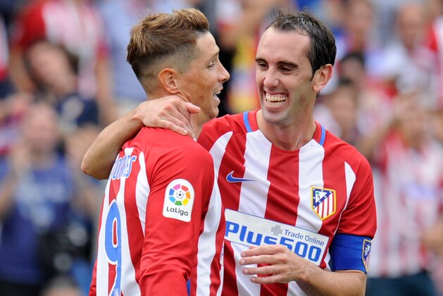 MADRID, SPAIN - SEPTEMBER 17:  Fernando Torres of Club Atletico de Madrid celebrates with Diego Godin  after scoring his team's 5th goal during the La Liga match between Club Atletico de Madrid and Real Sporting de Gijon at Vicente Calderon Stadium on September 17, 2016 in Madrid, Spain.  (Photo by Denis Doyle/Getty Images)