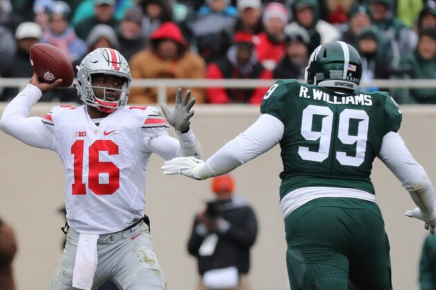 EAST LANSING, MI - NOVEMBER 19: J.T. Barrett #16 of the Ohio State Buckeye drops back to pass as Raequan Williams #99 of the Michigan State Spartans gives chase during the second quarter of the game at Spartan Stadium on November 19, 2016 in East Lansing, Michigan. (Photo by Leon Halip/Getty Images)