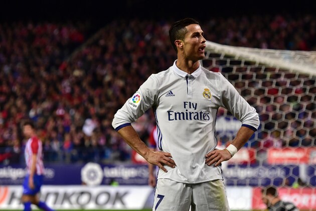 Real Madrid's Portuguese forward Cristiano Ronaldo celebrates after scoring his third goal during the Spanish league football match Club Atletico de Madrid vs Real Madrid CF at the Vicente Calderon stadium in Madrid, on November 19, 2016. / AFP / GERARD JULIEN        (Photo credit should read GERARD JULIEN/AFP/Getty Images)