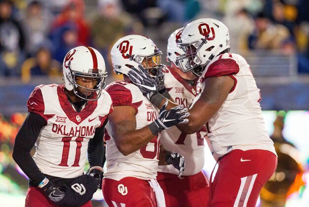 Nov 19, 2016; Morgantown, WV, USA; Oklahoma Sooners running back Samaje Perine (32) celebrates with teammates after scoring a touchdown during the second quarter against the West Virginia Mountaineers at Milan Puskar Stadium. Mandatory Credit: Ben Queen-USA TODAY Sports