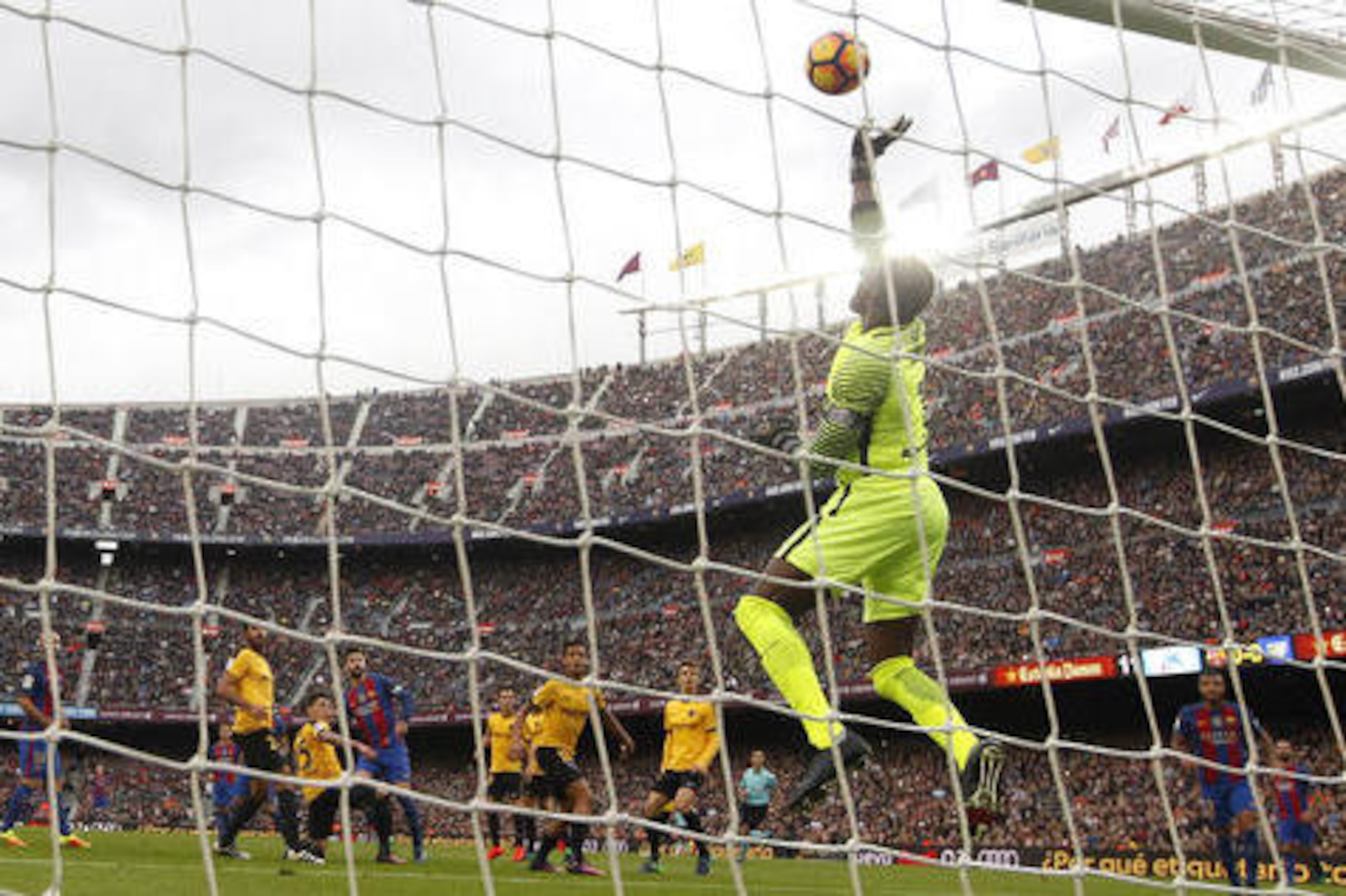 Malaga's goalkeeper Carlos Kameni, right, saves a ball during the Spanish La Liga soccer match between FC Barcelona and Malaga at the Camp Nou in Barcelona, Spain, Saturday, Nov. 19, 2016. (AP Photo/Manu Fernandez)