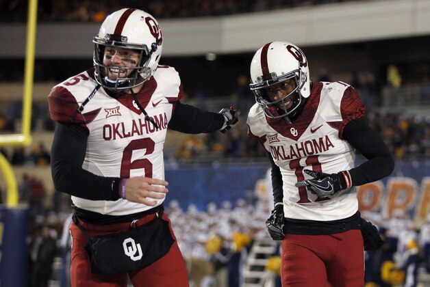 MORGANTOWN, WV - NOVEMBER 19:  Dede Westbrook #11 of the Oklahoma Sooners celebrates with Baker Mayfield #6 after scoring on a 75 yard touchdown pass against the West Virginia Mountaineers on November 19, 2016 at Mountaineer Field in Morgantown, West Virginia.  (Photo by Justin K. Aller/Getty Images)