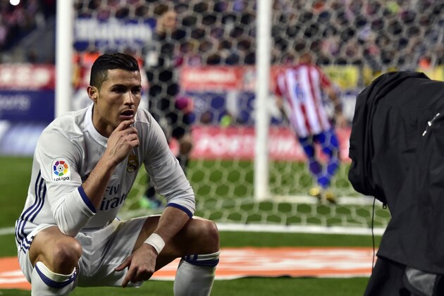 TOPSHOT - Real Madrid's Portuguese forward Cristiano Ronaldo poses in front of a TV camera as he celebrates after scoring during the Spanish league football match Club Atletico de Madrid vs Real Madrid CF at the Vicente Calderon stadium in Madrid, on November 19, 2016.
Real Madrid won 3-0. / AFP / GERARD JULIEN        (Photo credit should read GERARD JULIEN/AFP/Getty Images)