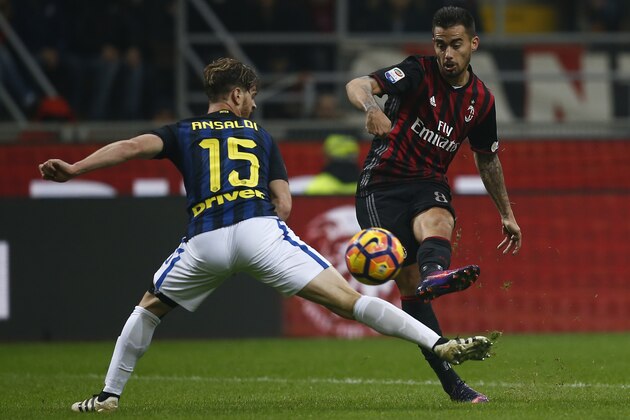 AC Milan's midfielder Suso from Spain (R) scores a goal during the Italian Serie A football match AC Milan Vs Inter Milan on November 20, 2016 at the 'San Siro Stadium' in Milan.  / AFP / MARCO BERTORELLO        (Photo credit should read MARCO BERTORELLO/AFP/Getty Images)
