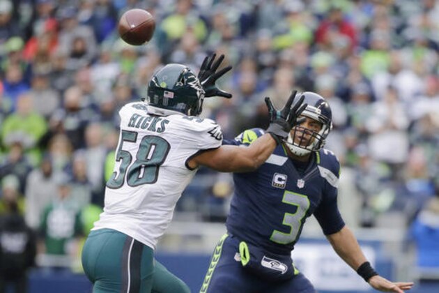 Seattle Seahawks quarterback Russell Wilson, right, throws a touchdown pass past Philadelphia Eagles middle linebacker Jordan Hicks (58) to hit Seahawks tight end Jimmy Graham (not shown) in the first half of an NFL football game, Sunday, Nov. 20, 2016, in Seattle. (AP Photo/John Froschauer)