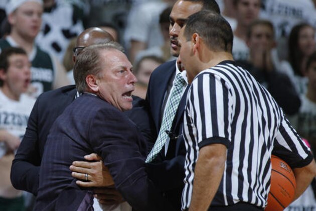 Michigan State coach Tom Izzo is held back by assistant coach Mike Garland, left rear, and director of basketball operations David Thomas, center, as he argues a call with official Bo Boroski, right, during the first half of an NCAA college basketball game against Florida Gulf Coast, Sunday, Nov. 20, 2016, in East Lansing, Mich. (AP Photo/Al Goldis)