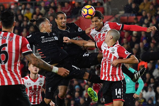 Liverpool's Brazilian midfielder Roberto Firmino (L) and Liverpool's German-born Cameroonian defender Joel Matip (2L) vie in the air with Southampton's Dutch defender Virgil van Dijk (2R) and Southampton's Sepanish midfielder Oriol Romeu during the English Premier League football match between Southampton and Liverpool at St Mary's Stadium in Southampton, southern England on November 19, 2016. / AFP / BEN STANSALL / RESTRICTED TO EDITORIAL USE. No use with unauthorized audio, video, data, fixture lists, club/league logos or 'live' services. Online in-match use limited to 75 images, no video emulation. No use in betting, games or single club/league/player publications.  /         (Photo credit should read BEN STANSALL/AFP/Getty Images)