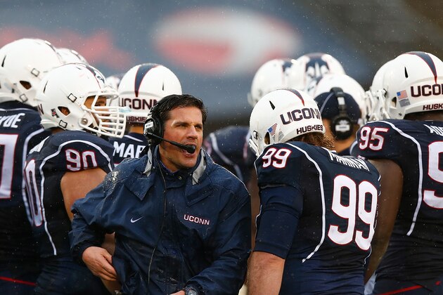 EAST HARTFORD, CT - DECEMBER 06:  Head coach Bob Diaco of the Connecticut Huskies stands in a huddle during a timeout in the second half against the SMU Mustangs during the game at Rentschler Field on December 6, 2014 in East Hartford, Connecticut.  (Photo by Jared Wickerham/Getty Images)