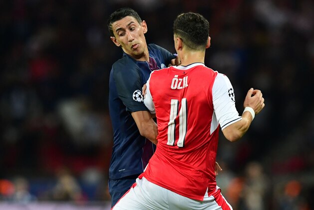 Paris Saint-Germain's Argentinian midfielder Angel Di Maria (L) vies with Arsenal's German midfielder Mesut Ozil during the UEFA Champions League Group A football match between Paris-Saint-Germain vs Arsenal FC, on September 13, 2016 at the Parc des Princes stadium in Paris.  AFP PHOTO / FRANCK FIFE / AFP / FRANCK FIFE        (Photo credit should read FRANCK FIFE/AFP/Getty Images)