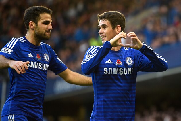 LONDON, ENGLAND - NOVEMBER 01:  Oscar of Chelsea celebrates his goal with Cesc Fabregas during the Barclays Premier League match between Chelsea and Queens Park Rangers at Stamford Bridge on November 1, 2014 in London, England.  (Photo by Mike Hewitt/Getty Images)