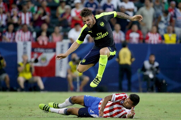 CARSON, CA - JULY 31:  Mathieu Debuchy #2 of Arsenal leaps over Hedgardo Marin #5 of Chivas de Guadalajara in the second half at StubHub Center on July 31, 2016 in Carson, California. Arsenal defeated Chivas de Guadalajara  3-1.  (Photo by Jeff Gross/Getty Images)
