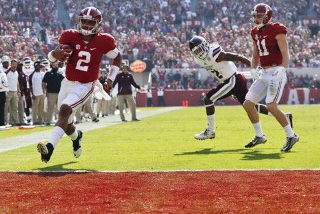 Alabama quarterback Jalen Hurts, left, scores a touchdown during the first half of an NCAA college football game against Mississippi State, Saturday, Nov. 12, 2016, in Tuscaloosa, Ala. (AP Photo/Brynn Anderson)