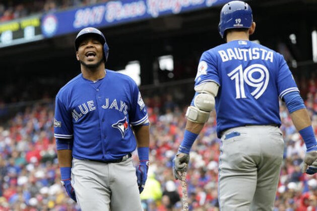 Toronto Blue Jays' Edwin Encarnacion, left, celebrates his solo home run with Jose Bautista (19) in the fifth inning of Game 2 of baseball's American League Division Series against the Texas Rangers on Friday, Oct. 7, 2016, in Arlington, Texas. (AP Photo/LM Otero)