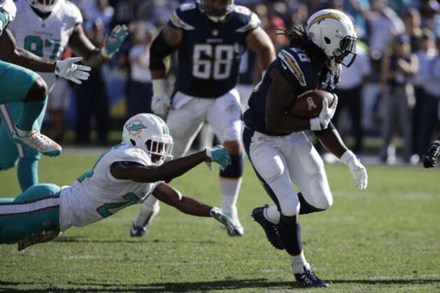 San Diego Chargers running back Melvin Gordon, right, runs past Miami Dolphins strong safety Isa Abdul-Quddus during the first half of an NFL football game in San Diego, Sunday, Nov. 13, 2016. (AP Photo/Gregory Bull)