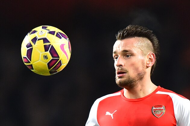 Arsenal's French defender Mathieu Debuchy eyes the ball during the English Premier League football match between Arsenal and Newcastle United at the Emirates Stadium in London on December 13, 2014. AFP PHOTO / BEN STANSALL

RESTRICTED TO EDITORIAL USE. No use with unauthorized audio, video, data, fixture lists, club/league logos or live services. Online in-match use limited to 45 images, no video emulation. No use in betting, games or single club/league/player publications.        (Photo credit should read BEN STANSALL/AFP/Getty Images)