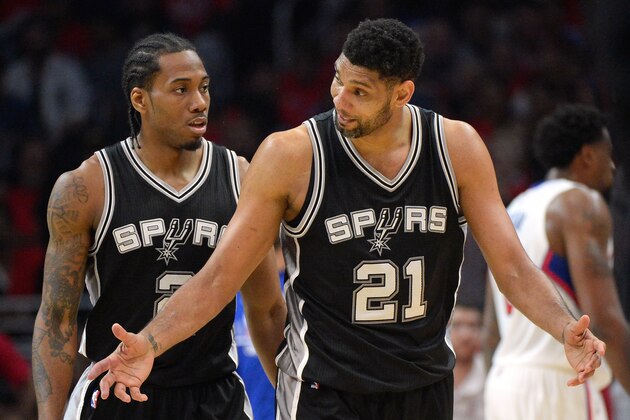 LOS ANGELES, CA - APRIL 22:  Tim Duncan #21 and Kawhi Leonard #2 of the San Antonio Spurs discuss a turnover during the first half of Game Two of the Western Conference quarterfinals of the 2015 NBA Playoffs at Staples Center on April 22, 2015 in Los Angeles, California.  NOTE TO USER: User expressly acknowledges and agrees that, by downloading and or using this Photograph, user is consenting to the terms and condition of the Getty Images License Agreement.  (Photo by Harry How/Getty Images)