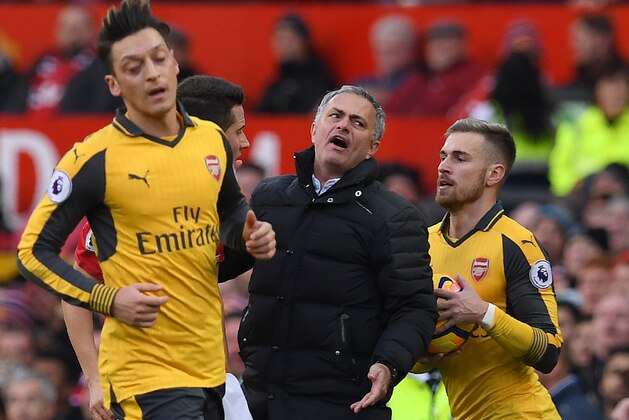 Manchester United's Portuguese manager Jose Mourinho (C) reacts after Arsenal's Spanish defender Nacho Monreal challenged Manchester United's Ecuadorian midfielder Antonio Valencia in the area, during the English Premier League football match between Manchester United and Arsenal at Old Trafford in Manchester, north west England, on November 19, 2016. / AFP / Paul ELLIS / RESTRICTED TO EDITORIAL USE. No use with unauthorized audio, video, data, fixture lists, club/league logos or 'live' services. Online in-match use limited to 75 images, no video emulation. No use in betting, games or single club/league/player publications.  /         (Photo credit should read PAUL ELLIS/AFP/Getty Images)