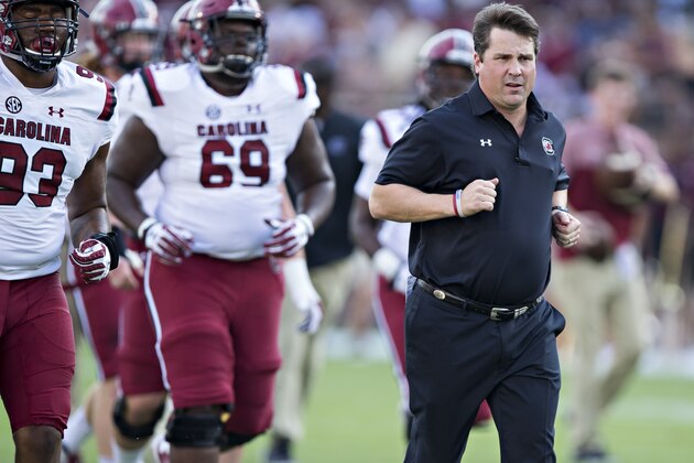 STARKVILLE, MS - SEPTEMBER 10:  Head Coach Will Muschamp of the South Carolina Gamecocks jogs with his team onto the field before a game against the Mississippi State Bulldogs at Davis Wade Stadium on September 10, 2016 in Starkville, Mississippi.  The Bulldogs defeated the Gamecocks 27-14.  (Photo by Wesley Hitt/Getty Images)
