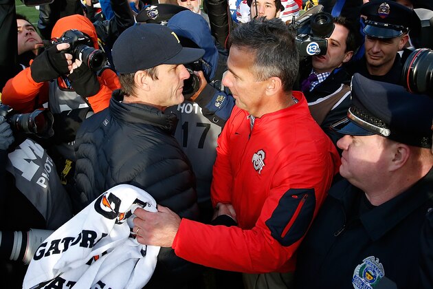 ANN ARBOR, MI - NOVEMBER 28:  Head coach Urban Meyer of the Ohio State Buckeyes shakes hands with head coach Jim Harbaugh of the Michigan Wolverines after a 42-13 Ohio State win at Michigan Stadium on November 28, 2015 in Ann Arbor, Michigan.  (Photo by Gregory Shamus/Getty Images)