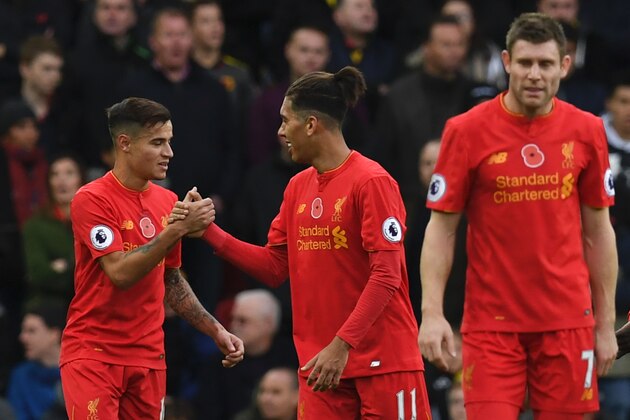 Liverpool's Brazilian midfielder Philippe Coutinho (L) celebrates scoring his team's second goal with Liverpool's Brazilian midfielder Roberto Firmino  (C) during the English Premier League football match between Liverpool and Watford at Anfield in Liverpool, north west England on November 6, 2016. / AFP / PAUL ELLIS / RESTRICTED TO EDITORIAL USE. No use with unauthorized audio, video, data, fixture lists, club/league logos or 'live' services. Online in-match use limited to 75 images, no video emulation. No use in betting, games or single club/league/player publications.  /         (Photo credit should read PAUL ELLIS/AFP/Getty Images)