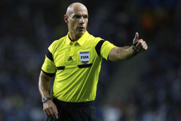 FILE - In this Tuesday, Oct. 1, 2013 file photo, referee Howard Webb gestures during the Champions League group G soccer match between FC Porto and Atletico de Madrid in Porto, northern Portugal. Moments before the start of the most game of his life, Webb had been struck down by another bout of Obsessive compulsive disorder, a condition in which a person has obsessive thoughts and compulsive behavior. Webb kept the condition secret throughout a career that saw him referee the Champions League final and World Cup final in the same year, 2010, fearing the harsh world of soccer would mark him down as mentally unsound. (AP Photo/Armando Franca, file)