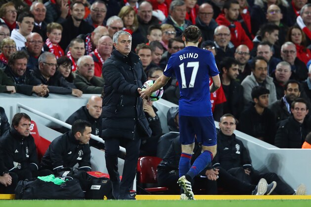 LIVERPOOL, ENGLAND - OCTOBER 17:  Jose Mourinho, Manager of Manchester United gives the ball to Daley Blind of Manchester United during the Premier League match between Liverpool and Manchester United at Anfield on October 17, 2016 in Liverpool, England.  (Photo by Clive Brunskill/Getty Images)