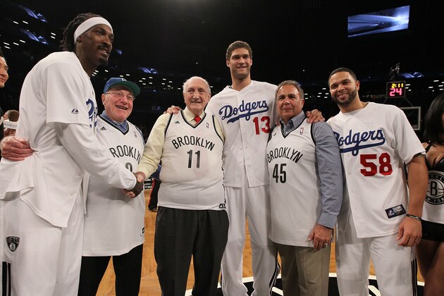 NEW YORK, NY - NOVEMBER 03:  (NEW YORK DAILIES OUT)  Gerald Wallace #45,  Brook Lopez (13) and Deron Williams (58) of the Brooklyn Nets pose for a photograph with former Brooklyn Dodgers Joe Pignatano (8),  Ralph Branca (11) and Gil Hodges Jr., son of former Dodger Gil Hodges, before a game against the Toronto Raptors at the Barclays Center on November 3, 2012 in the Brooklyn borough of New York City.The Nets defeated the Raptors 107-100 to win the first regular season game to be played at the new Barclays Center. NOTE TO USER: User expressly acknowledges and agrees that, by downloading and/or using this Photograph, user is consenting to the terms and conditions of the Getty Images License Agreement.  (Photo by Jim McIsaac/Getty Images)