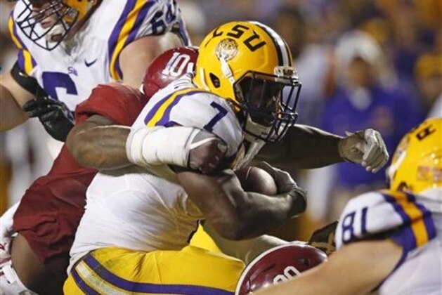 LSU running back Leonard Fournette (7) is stopped by Alabama linebacker Reuben Foster (10) in the second half of an NCAA college football game in Baton Rouge, La., Saturday, Nov. 5, 2016. Alabama won 10-0. (AP Photo/Gerald Herbert)