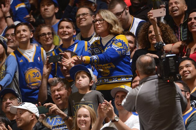 OAKLAND, CA - NOVEMBER 13:  A Golden State Warriors fan dressed in a Warriors NBA championship Christmas sweater, dances her heart out during the game against the Phoenix Suns 
on November 13, 2016 at ORACLE Arena in Oakland, California. NOTE TO USER: User expressly acknowledges and agrees that, by downloading and or using this photograph, user is consenting to the terms and conditions of Getty Images License Agreement. Mandatory Copyright Notice: Copyright 2016 NBAE (Photo by Noah Graham/NBAE via Getty Images)