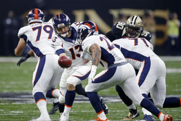 Denver Broncos quarterback Trevor Siemian (13) hands off to running back Devontae Booker (23) in the first half of an NFL football game in New Orleans, Sunday, Nov. 13, 2016. (AP Photo/John McCusker)