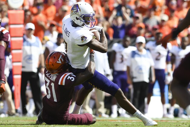 BLACKSBURG, VA - SEPTEMBER 24: Wide receiver Zay Jones #7 of the East Carolina Pirates is hit after his reception by cornerback Brandon Facyson #31 of the Virginia Tech Hokies in the second half at Lane Stadium on September 24, 2016 in Blacksburg, Virginia. Virginia Tech defeated East Carolina 54-17 (Photo by Michael Shroyer/Getty Images)