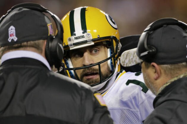 Green Bay Packers quarterback Aaron Rodgers (12) talks with coaches on the sidelines during the second half of an NFL football game against the Washington Redskins in Landover, Md., Sunday, Nov. 20, 2016. (AP Photo/Mark Tenally)