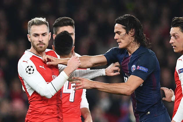Paris Saint-Germain's Uruguayan forward Edinson Cavani (2R) scuffles with Arsenal's Welsh midfielder Aaron Ramsey (L) after Arsenal were awarded a penalty during the UEFA Champions League group A football match between Arsenal and Paris Saint-Germain at the Emirates Stadium in London on November 23, 2016.  / AFP / Justin TALLIS        (Photo credit should read JUSTIN TALLIS/AFP/Getty Images)