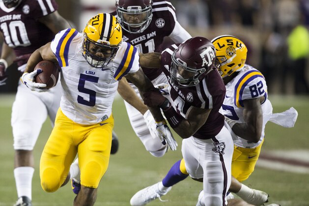 COLLEGE STATION, TX - NOVEMBER 24:  Derrius Guice #5 of the LSU Tigers breaks the tackle of Justin Evans #14 of the Texas A&M Aggies for a 45 yard score in the first quarter at Kyle Field on November 24, 2016 in College Station, Texas.  (Photo by Bob Levey/Getty Images)