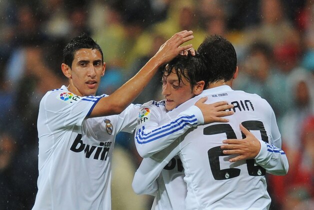 MADRID, SPAIN - OCTOBER 03:  Mesut Ozil (C) of Real Madrid is congratulated by Angel di Maria (L) and Gonzalo Higuain after scoring Real's 2nd goal  during the La Liga match between Real Madrid and Deportivo La Coruna at Estadio Santiago Bernabeu on October 3, 2010 in Madrid, Spain.  (Photo by Denis Doyle/Getty Images)