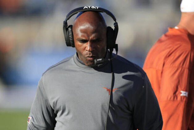 Texas head coach Charlie Strong walks the sideline during the first half of an NCAA college football game against Kansas in Lawrence, Kan., Saturday, Nov. 19, 2016. (AP Photo/Orlin Wagner)