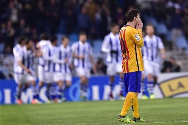 Barcelona's Lionel Messi of Argentina, right, laments as Real Sociedad's players celebrates their goal during their Spanish La Liga soccer match between Barcelona and Real Sociedad, at Anoeta stadium in San Sebastian, northern Spain, Saturday, April 9, 2016. Barcelona lost 1-0. (AP Photo/Alvaro Barrientos)